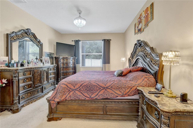 bedroom with light colored carpet and multiple windows