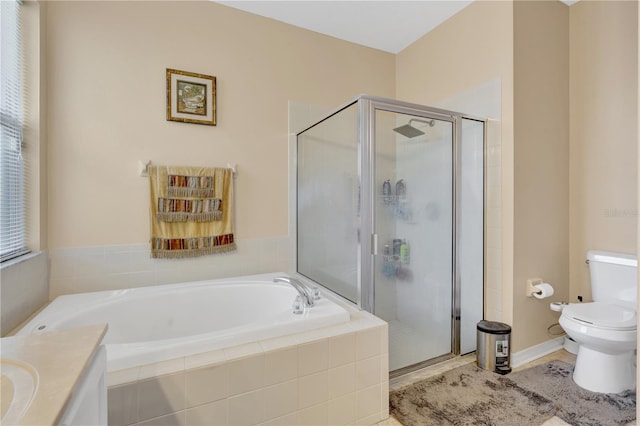 full bathroom with shower with separate bathtub, vanity, and toilet