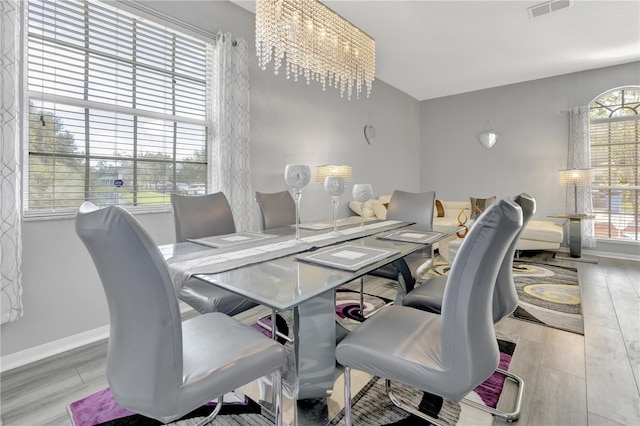 dining space with a wealth of natural light and light hardwood / wood-style flooring