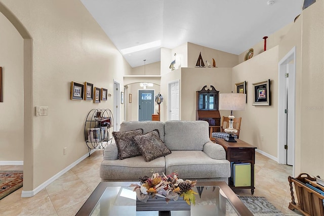 living room with high vaulted ceiling and light tile patterned floors