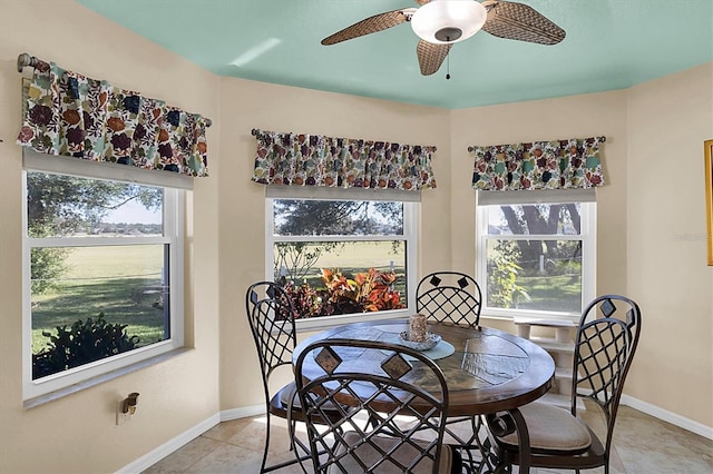 tiled dining area featuring ceiling fan and plenty of natural light