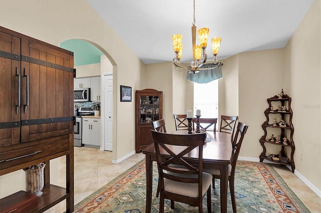 dining room with an inviting chandelier and light tile patterned floors