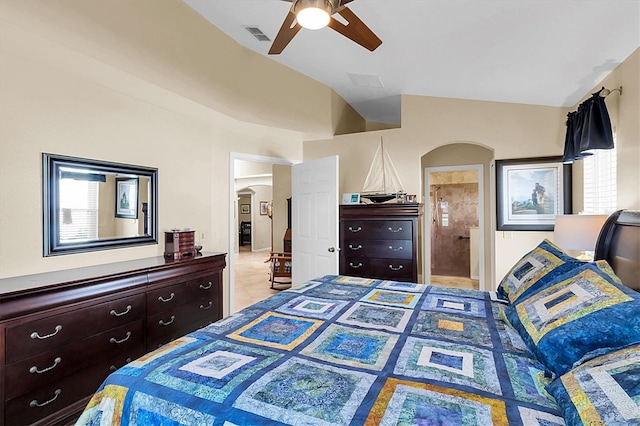 tiled bedroom with connected bathroom, ceiling fan, and lofted ceiling