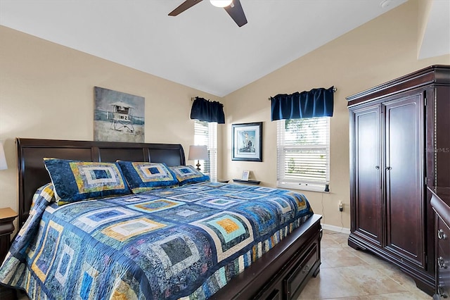 tiled bedroom with lofted ceiling and ceiling fan