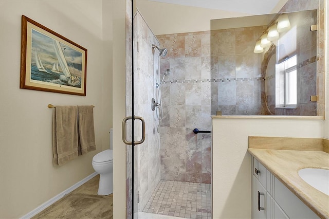 bathroom with vanity, tile patterned flooring, toilet, and an enclosed shower