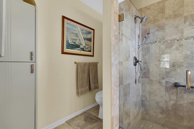 bathroom with toilet, tile patterned floors, and an enclosed shower