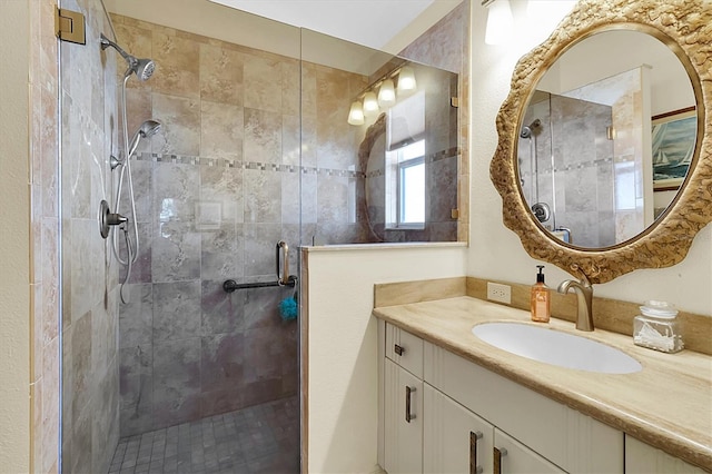 bathroom featuring vanity and a shower with shower door