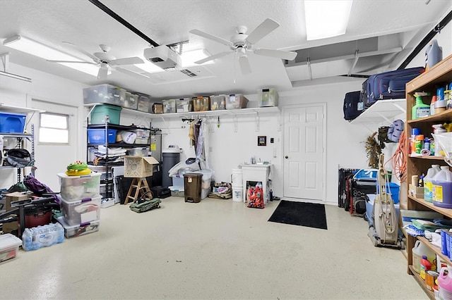 interior space with a garage door opener and ceiling fan