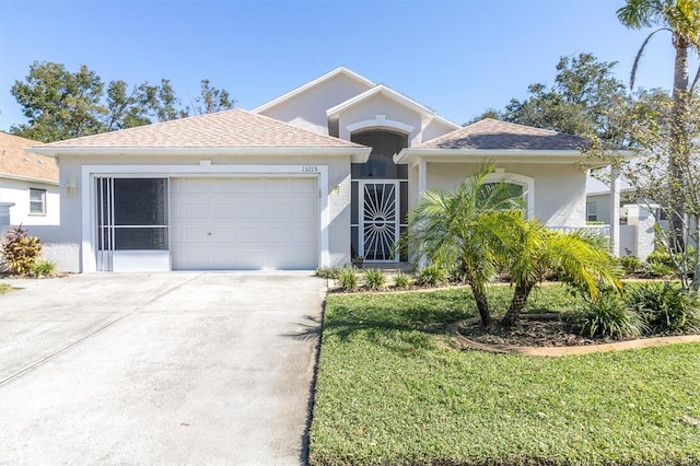 view of front of home with a front lawn and a garage