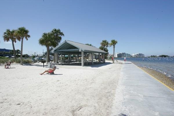 view of property's community featuring a water view, a view of the beach, and a gazebo