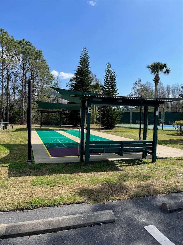 view of basketball court with a lawn