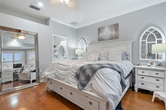 bedroom with ceiling fan, wood-type flooring, and crown molding