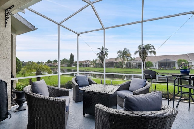 sunroom featuring a water view