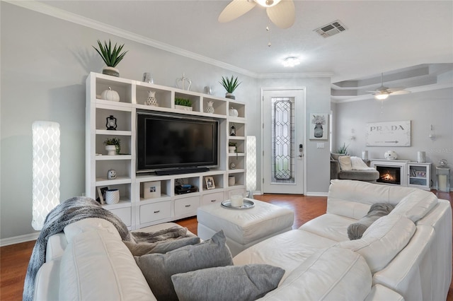 living room with wood-type flooring and ornamental molding