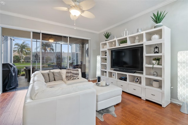 living room with crown molding, plenty of natural light, ceiling fan, and hardwood / wood-style flooring