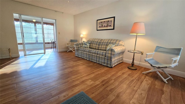 living room with hardwood / wood-style flooring and a textured ceiling