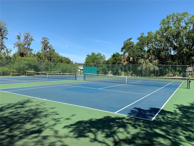 view of tennis court with basketball hoop