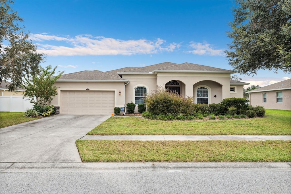 view of front facade with a front yard and a garage