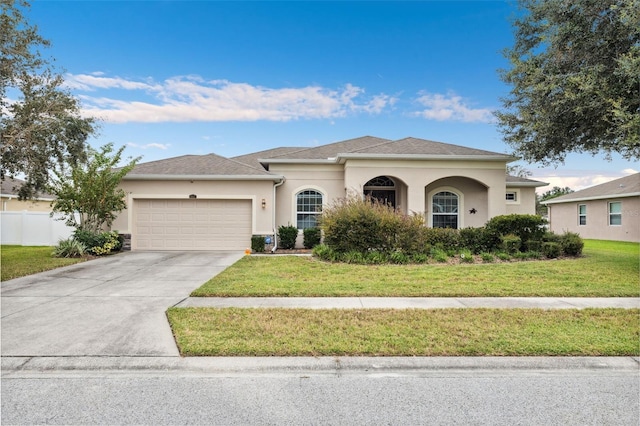 view of front facade with a front yard and a garage