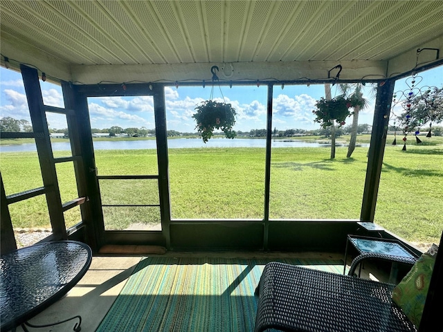 sunroom with a healthy amount of sunlight and a water view