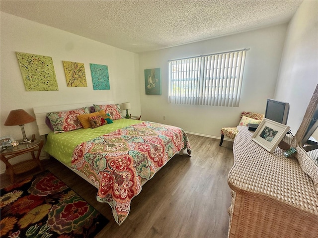 bedroom featuring hardwood / wood-style flooring and a textured ceiling