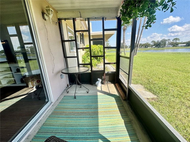 unfurnished sunroom featuring a water view and plenty of natural light