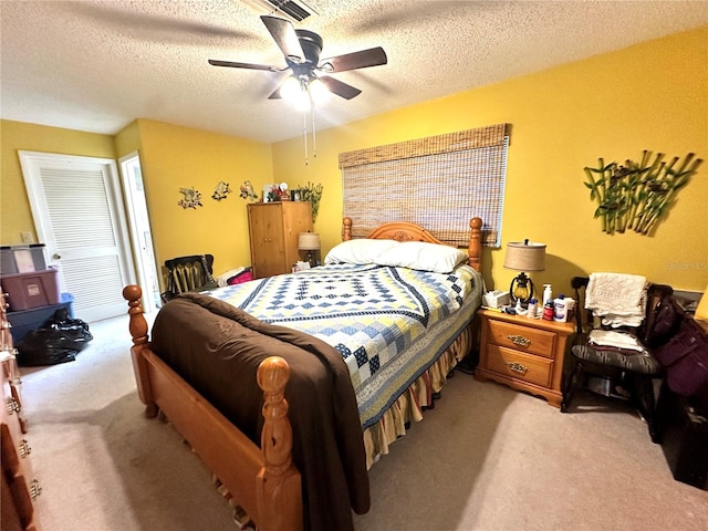 carpeted bedroom with a textured ceiling and ceiling fan