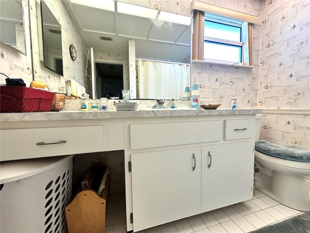 bathroom with vanity, tile patterned floors, and toilet