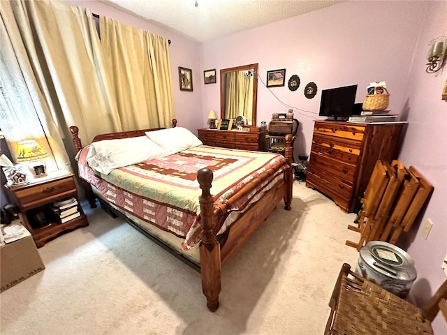 bedroom with a textured ceiling and light colored carpet