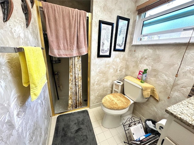 bathroom featuring vanity, tile patterned floors, toilet, and walk in shower