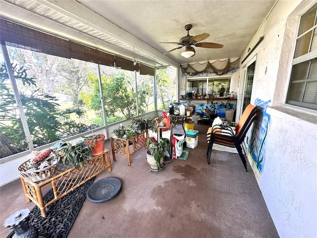 sunroom featuring ceiling fan