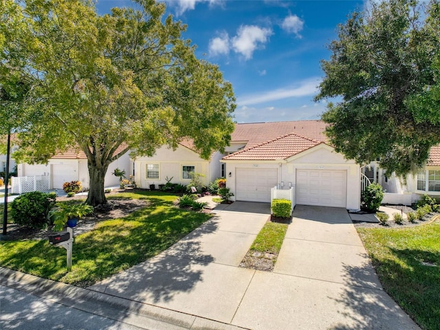 mediterranean / spanish-style house with a front lawn and a garage