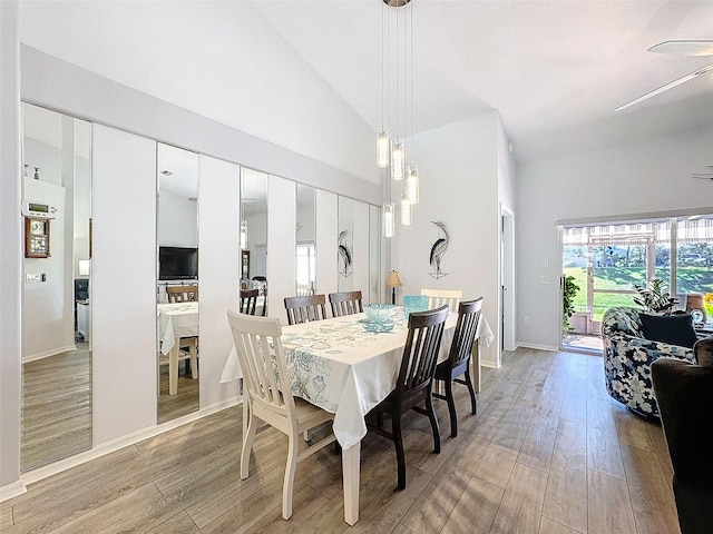 dining room featuring lofted ceiling, light hardwood / wood-style flooring, and ceiling fan