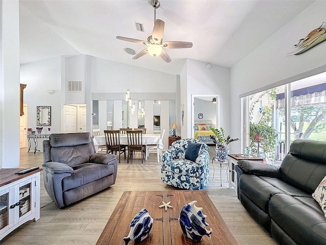 living room featuring light hardwood / wood-style floors, high vaulted ceiling, and ceiling fan