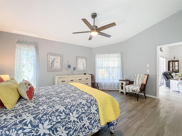 bedroom featuring lofted ceiling, hardwood / wood-style flooring, and ceiling fan