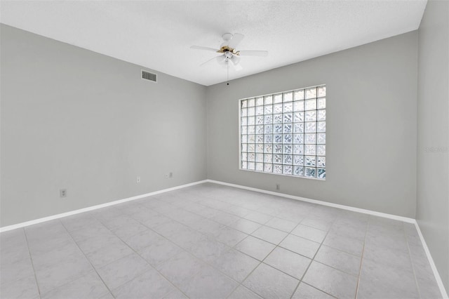 spare room featuring a textured ceiling and ceiling fan