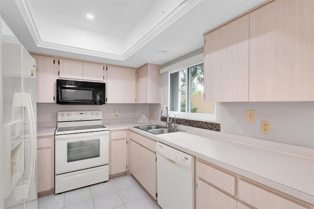 kitchen with a tray ceiling, sink, light tile patterned floors, light brown cabinetry, and white appliances