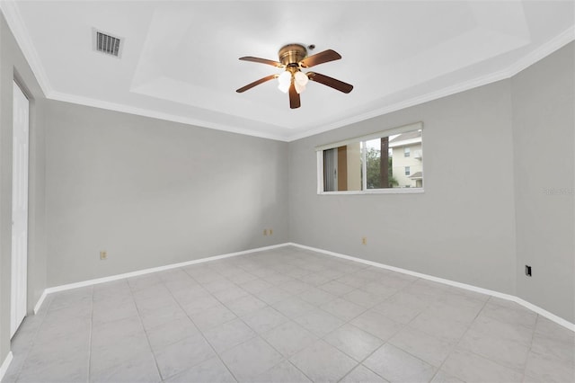 spare room featuring crown molding, a raised ceiling, and ceiling fan