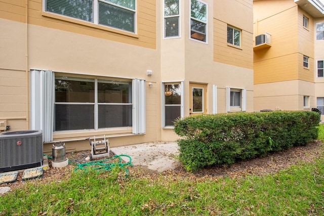 back of house featuring central AC unit