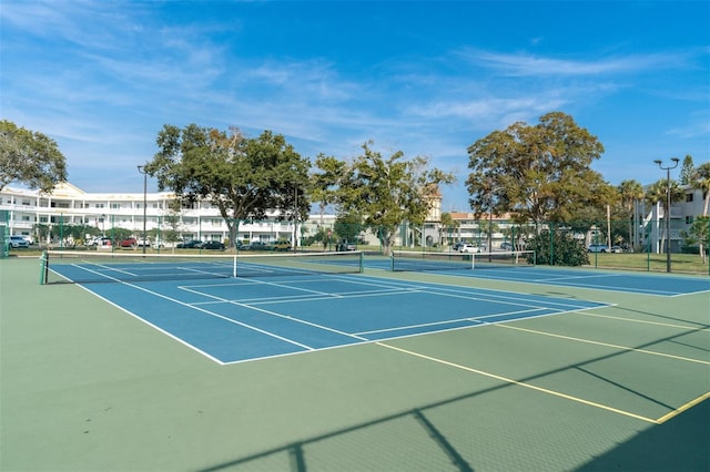 view of tennis court with basketball hoop