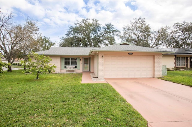 single story home with a garage and a front lawn