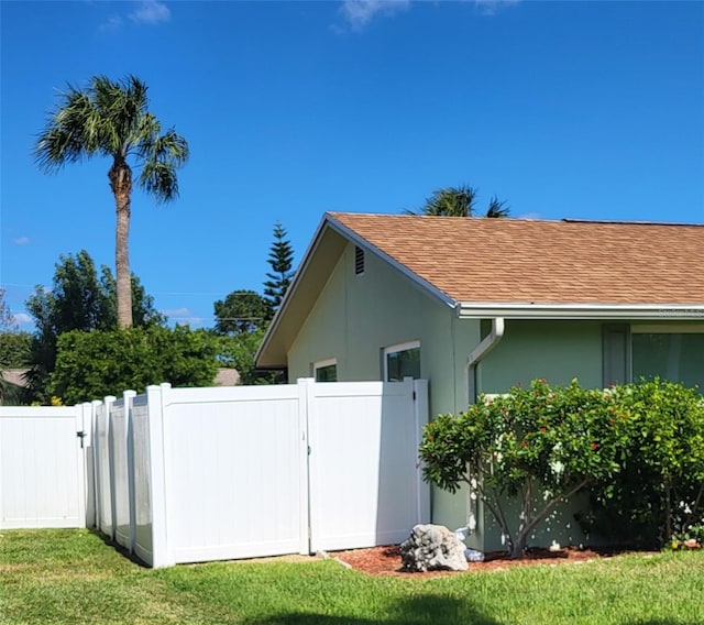 view of side of home featuring a lawn