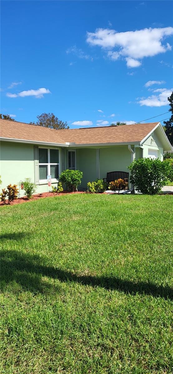 view of side of home featuring a lawn