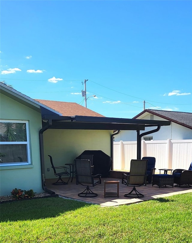 back of house with a patio area and a yard