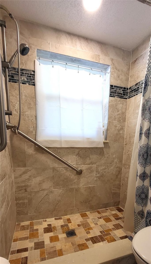 bathroom with a shower with curtain and toilet