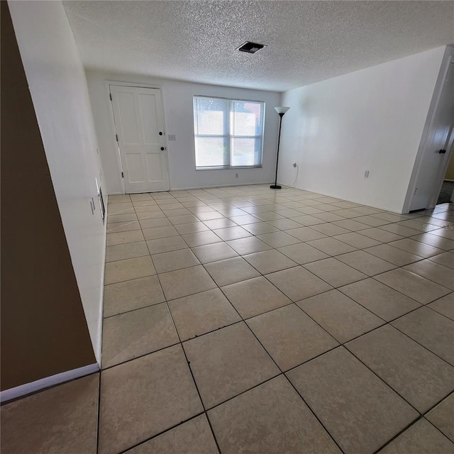 tiled foyer entrance featuring a textured ceiling