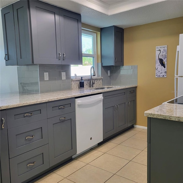 kitchen featuring white appliances, sink, gray cabinets, tasteful backsplash, and light tile patterned flooring