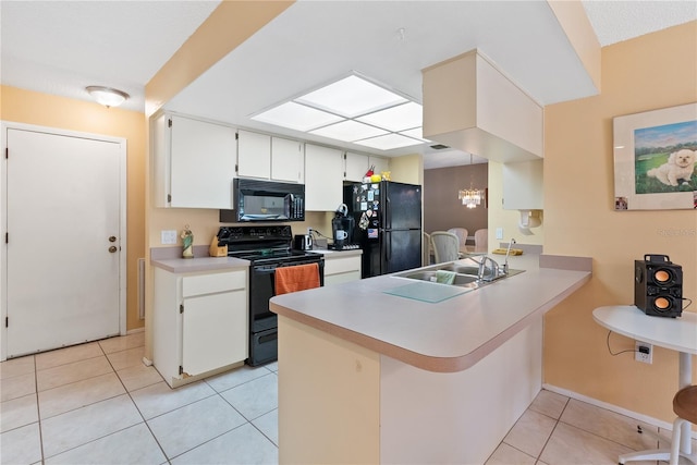 kitchen with black appliances, white cabinets, kitchen peninsula, and light tile patterned floors