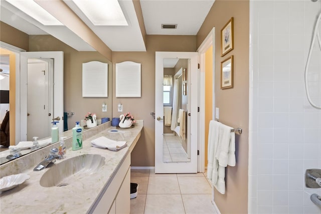 bathroom featuring vanity, tile patterned floors, and walk in shower