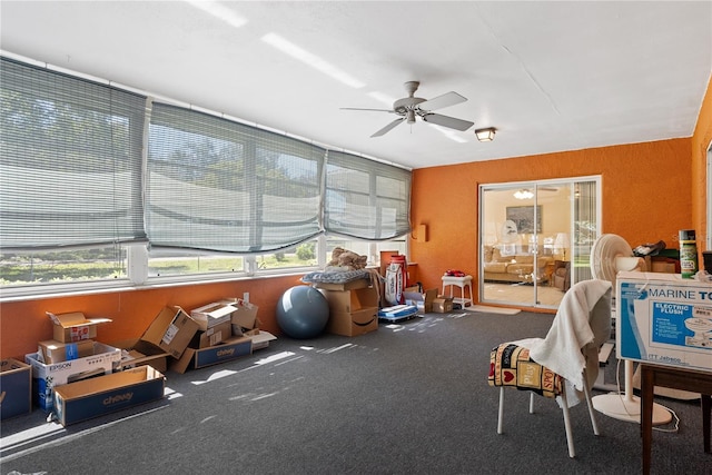 sunroom featuring ceiling fan